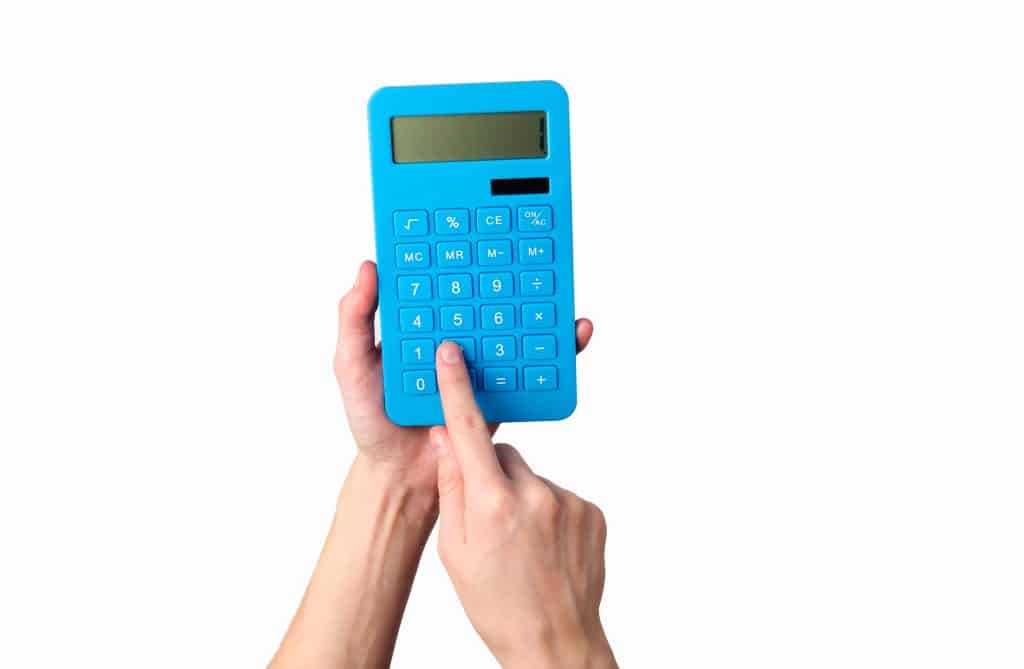 Hand holds blue calculator Isolated on a white background